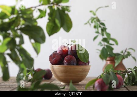 Fresh plum. Harvest. Autumn harvest. Blue plums. Plums on a wooden surface. Fresh plums on wooden table background. Stock Photo