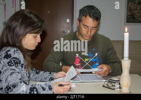 Image of a man and woman checking their electricity and gas bills. Economic problems due to the current global energy crisis Stock Photo