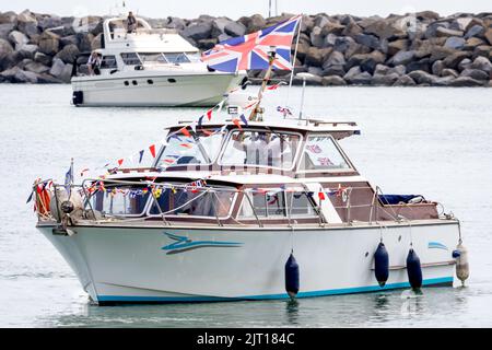 Sovereign Harbour, Eastbourne, UK. 27th Aug, 2022. Earlier today a flotilla of small boats including the RNLI All Weather lifeboat Diamond Jubilee sailed from Eastbourne's Sovereign Harbour to the Sovereign lighthouse just 11km off shore. The once manned lighthouse was commissioned in 1971 serving mariners for over 50 years. Lighthouse men left the platform in 1994 following its automation. Having now reached the end of its predicted life the structure is to be removed for safety reasons. Credit: Newspics UK South/Alamy Live News Stock Photo