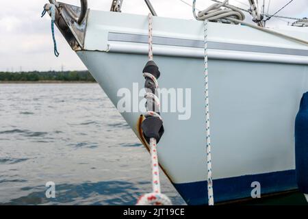 Yacht moored. mooring line with rubber compensator snubber. Stock Photo