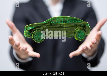 A 3D rendering of floating holographic smart car in a businessman's hand Stock Photo