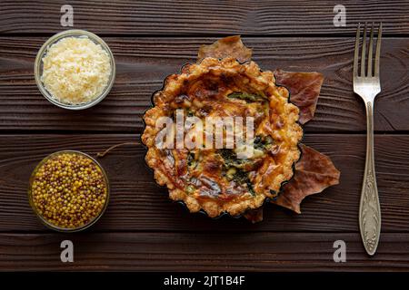 Tasty baked mini vegetable pie on wooden rustic table, top view. Stock Photo