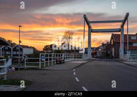 Bridge over the sluice in the village of Spaarndam, Province North Holland, by sunset Stock Photo