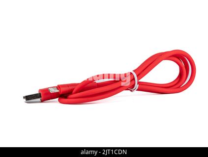 Red cable with USB and mini-USB connectors on a white background. Copy space. Stock Photo