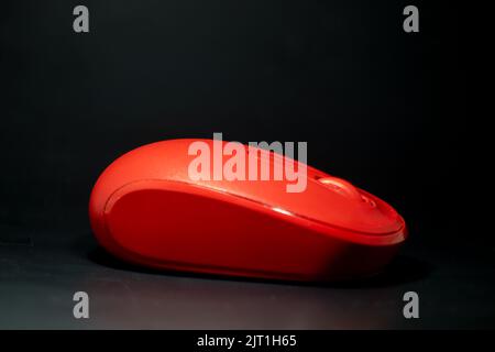 Red wireless mouse on the isolated black background Stock Photo