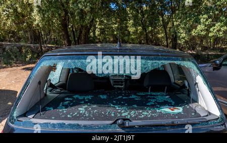 Smashed rear car window from vehicle burglary left on a car park in a village in France Stock Photo
