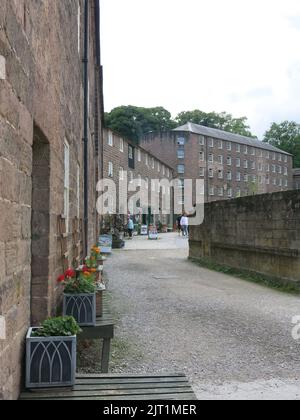 The courtyard at Cromford Mills in Derbyshire, the origins of the British Cotton Industry with Arkwright's first water-powered cotton spinning mill. Stock Photo