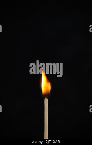 one long match stick burning against black background Stock Photo - Alamy