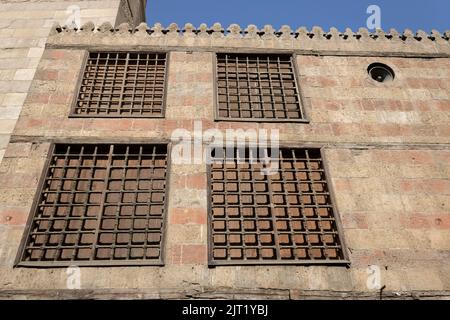 Old Islamic Stone Wall with Traditional Wood and Steel Bars Windows Stock Photo
