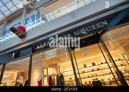 SINGAPORE - JANUARY 20, 2020: Alexander McQueen brand name over a store entrance in the Shoppes at Marina Bay Sands. Alexander McQueen is a British lu Stock Photo