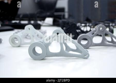 Black white gray models printed on 3D printer in laboratory office. Objects printed on 3D printer from plastic. Prototypes made on 3d printer. Concept new modern printing technology. Multi Jet Fusion Stock Photo