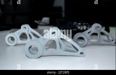 Black white gray models printed on 3D printer in laboratory office. Objects printed on 3D printer from plastic. Prototypes made on 3d printer. Concept new modern printing technology. Multi Jet Fusion Stock Photo