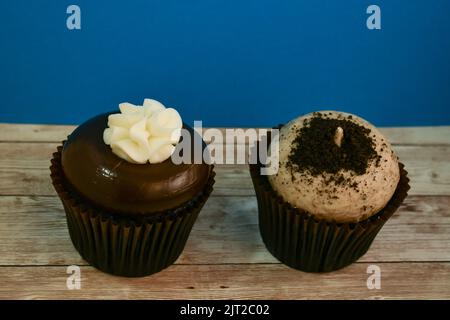 Two types of chocolate cupcakes together indoors background Stock Photo