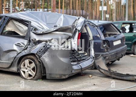 Broken car after a traffic accident in the parking lot of a repair station.  Car body