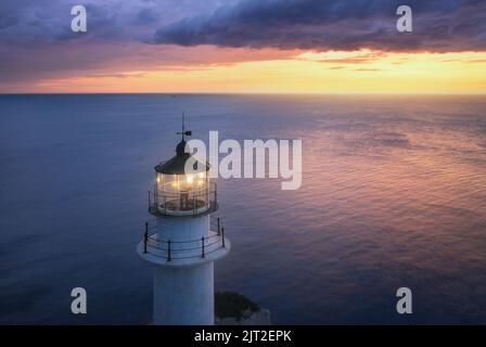 Lighthouse at colorful sunset in summer. Aerial view from drone Stock Photo