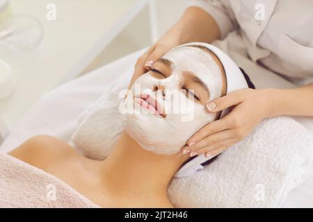 Beautiful young woman getting cosmetic facial treatment in spa center or beauty salon Stock Photo