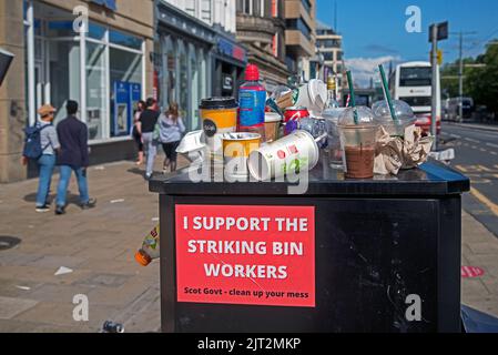 Discarded rubbish and sign of support on Princes Street due to industrial action by Edinburgh council workers. Stock Photo