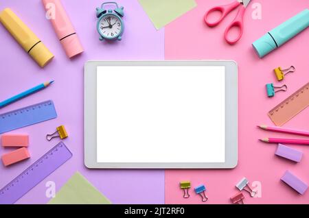 Digital tablet mock up template screen on school stationery pastel background. Stock Photo