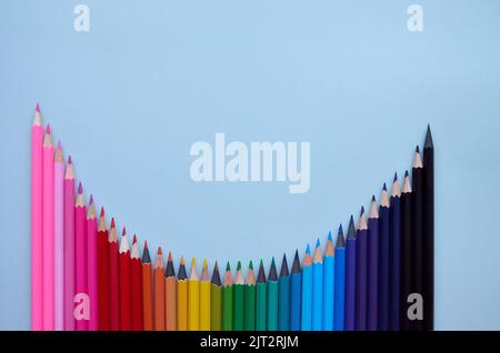 Many color pencils wave on grey background, flatlay. Back to school Stock Photo
