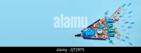 School stationery in rocket form concept on grey background, flatlay. Stock Photo
