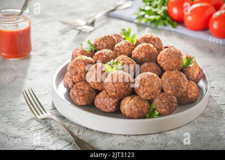 Middle Eastern traditional spiced meatballs ". Served with tomato sauce. Close up with copy space. Stock Photo