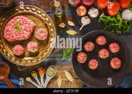 Preparation for delicious Middle Eastern recipe.  Ground meat with fresh ingredients to make tasty meatballs meal. Top view with copy space. Stock Photo