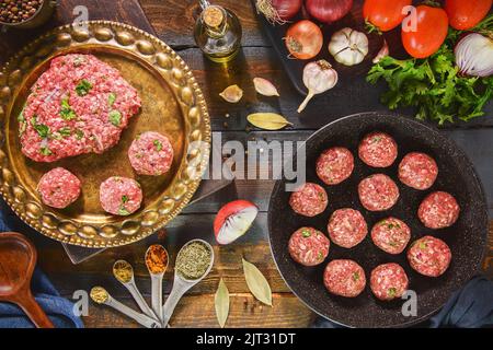Preparation for delicious Middle Eastern recipe.  Ground meat with fresh ingredients to make tasty meatballs meal. Top view with copy space. Stock Photo