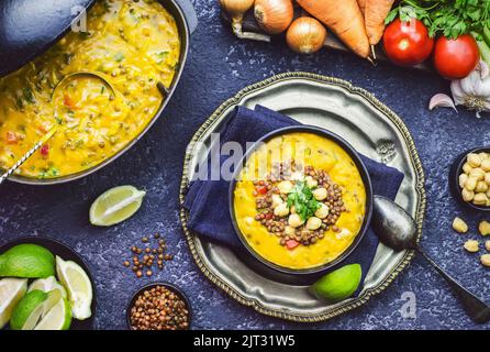 Harira- a Moroccan traditional spiced chickpea ,lentil and vegetables soup. Vegetarian lentil soup decorated with parsley. Top view with close-up. Stock Photo