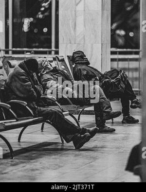 A grayscale shot of sleeping homeless people Stock Photo