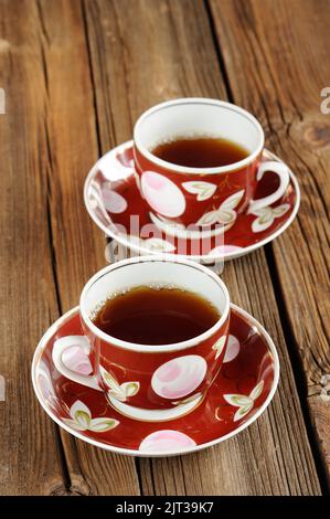 Two cups of black tea with wooden background vertical Stock Photo