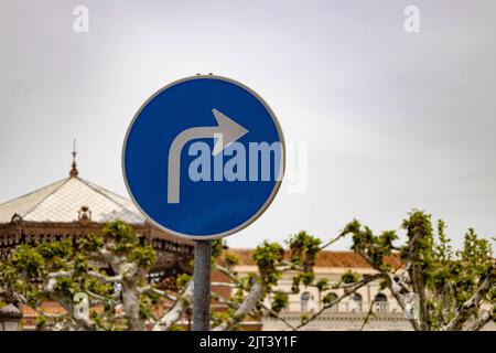 Traffic sign to indicate right turn. Arrow curved on a billboard in the street. Sign for motorists. Stock Photo