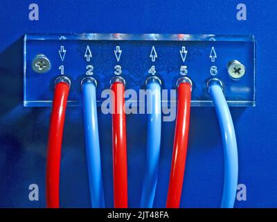 red and blue connected cables pack heap on blue surface. color power electricity numbers concept Stock Photo