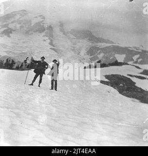 Two men, Plummer and Holmes, on a snow slope in Paradise Park, Mount Rainier, August 1896 (SARVANT 61). Stock Photo