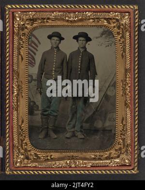Two unidentified young soldiers in Union uniforms in front of painted ...