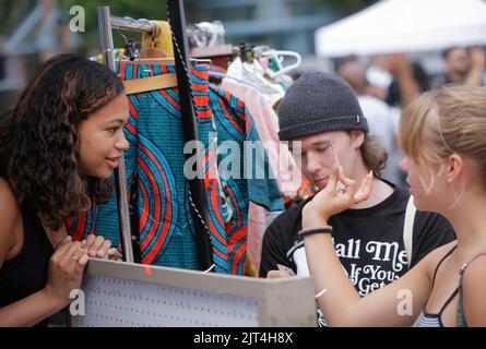 Vancouver, Canada. 27th Aug, 2022. Customers view handmade ornaments at a vendor's booth during the Black Block Party, an event organized by local black community, in Vancouver, British Columbia, Canada, on Aug. 27, 2022. Credit: Liang Sen/Xinhua/Alamy Live News Stock Photo