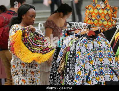 Vancouver, Canada. 27th Aug, 2022. A vendor arranges clothes during the Black Block Party, an event organized by local black community, in Vancouver, British Columbia, Canada, on Aug. 27, 2022. Credit: Liang Sen/Xinhua/Alamy Live News Stock Photo