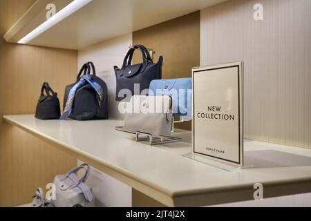 SINGAPORE - CIRCA JANUARY, 2020: bags on display at Longchamp store in Singapore Changi Airport. Stock Photo