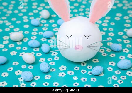 A bunny head with blue and white chocolate eggs Stock Photo