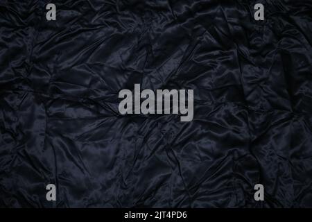 Black shining silk fabric - wavy and Shiny texture of soft silk fabric - - luxury silk fabric stock photo Stock Photo