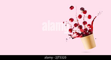 Flying cherries vertical isolated as package design elements. Fresh raw cheery falling in the air Stock Photo