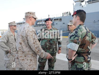 U.S. Marines speak with Dutch marines before getting onto the Royal Netherlands Navy landing platform dock ship HNLMS Rotterdam (L800) for Africa Partnership Station (APS) in Rota, Spain, Aug. 30, 2013 130830 Stock Photo