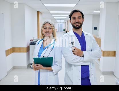 medical teamwork. Portrait of happy medical team standing in hospital corridor after hard working day Stock Photo