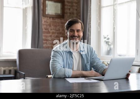 Happy successful business leader man sitting at work table Stock Photo