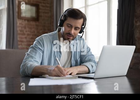 Busy employee man in wireless headset talking to client Stock Photo