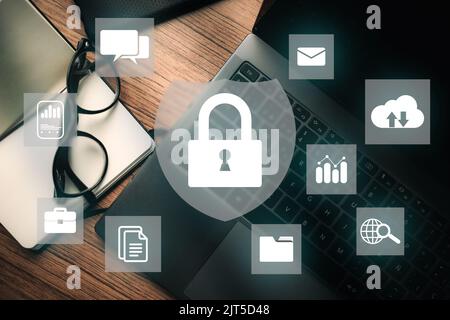 Virtual interface with lock security shield and desktop photo as background. Cybersecurity concept global. Data protection against cyber attack. Stock Photo