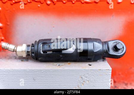 Close-up. air ratchet wrench. angular pneumatic wrench on a gray background.. Tools for car repair. motorcycle repair Stock Photo