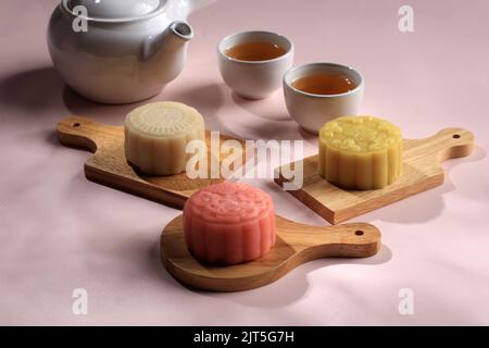 Colorful Snow Skin Moon Cake, Sweet Mochi Mooncake, Traditional Sweet Dessert for Mid Autumn Festival, Served with Tea. Copy Space for Text Stock Photo