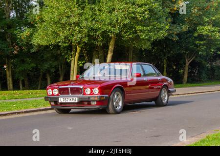 1994 90s nineties British JAGUAR Red XJ Gold 3239cc petrol 4 speed automatic; arriving at The annual Stanley Park Classic Car Show in the Italian Gardens. Stanley Park classics yesteryear Motor Show Hosted By Blackpool Vintage Vehicle Preservation Group, UK. Stock Photo