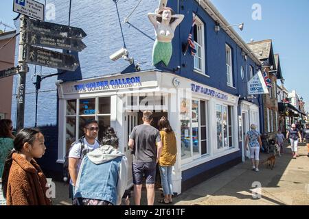 Aldeburgh, Suffolk, England, June 26th 2022, people queue outside a chip shop in the town Stock Photo