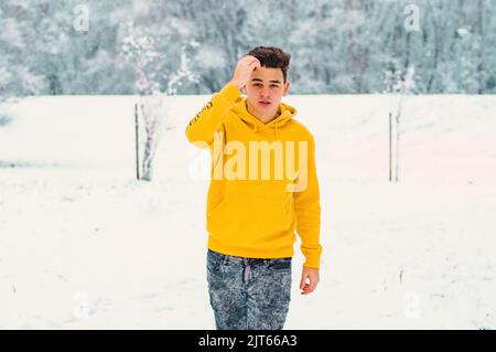 handsome man walking in a snow Stock Photo